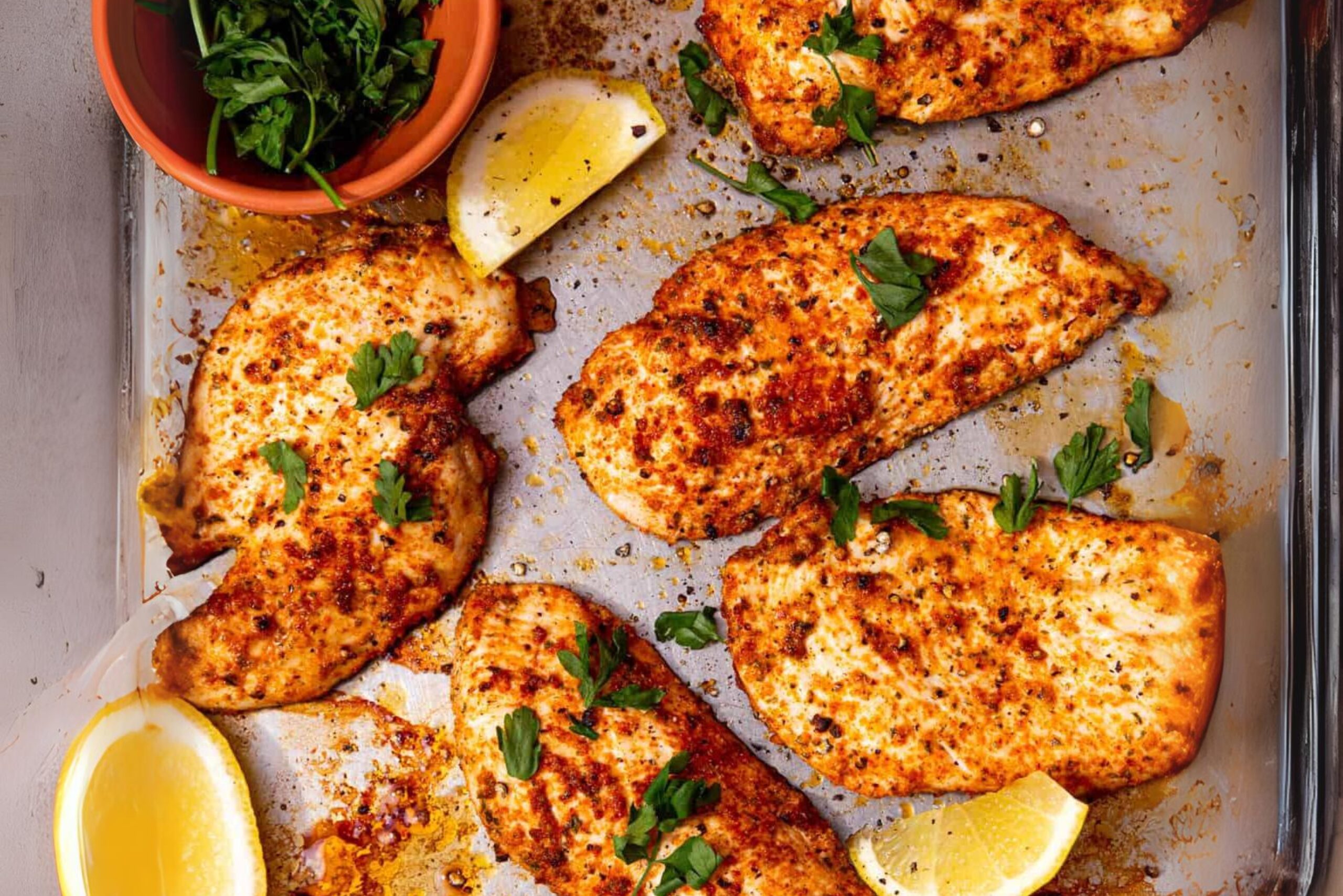 Plate of thin sliced chicken breast with herbs and spices