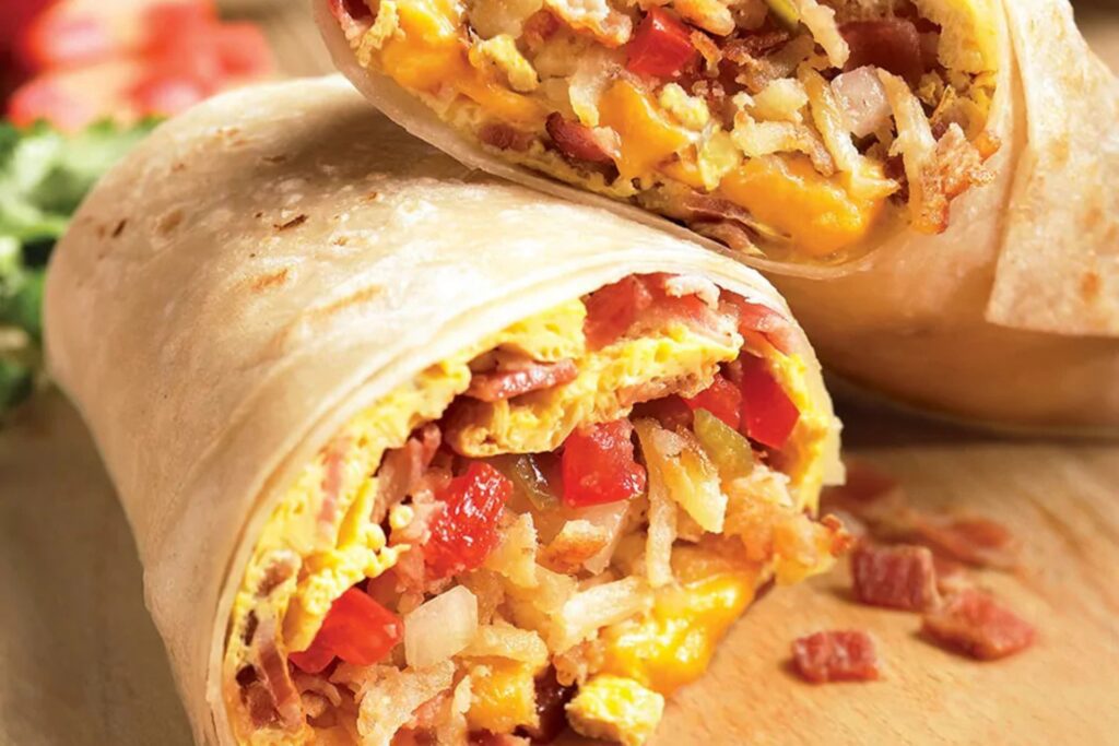 Close-up of a breakfast burrito with rice, eggs, and cheese